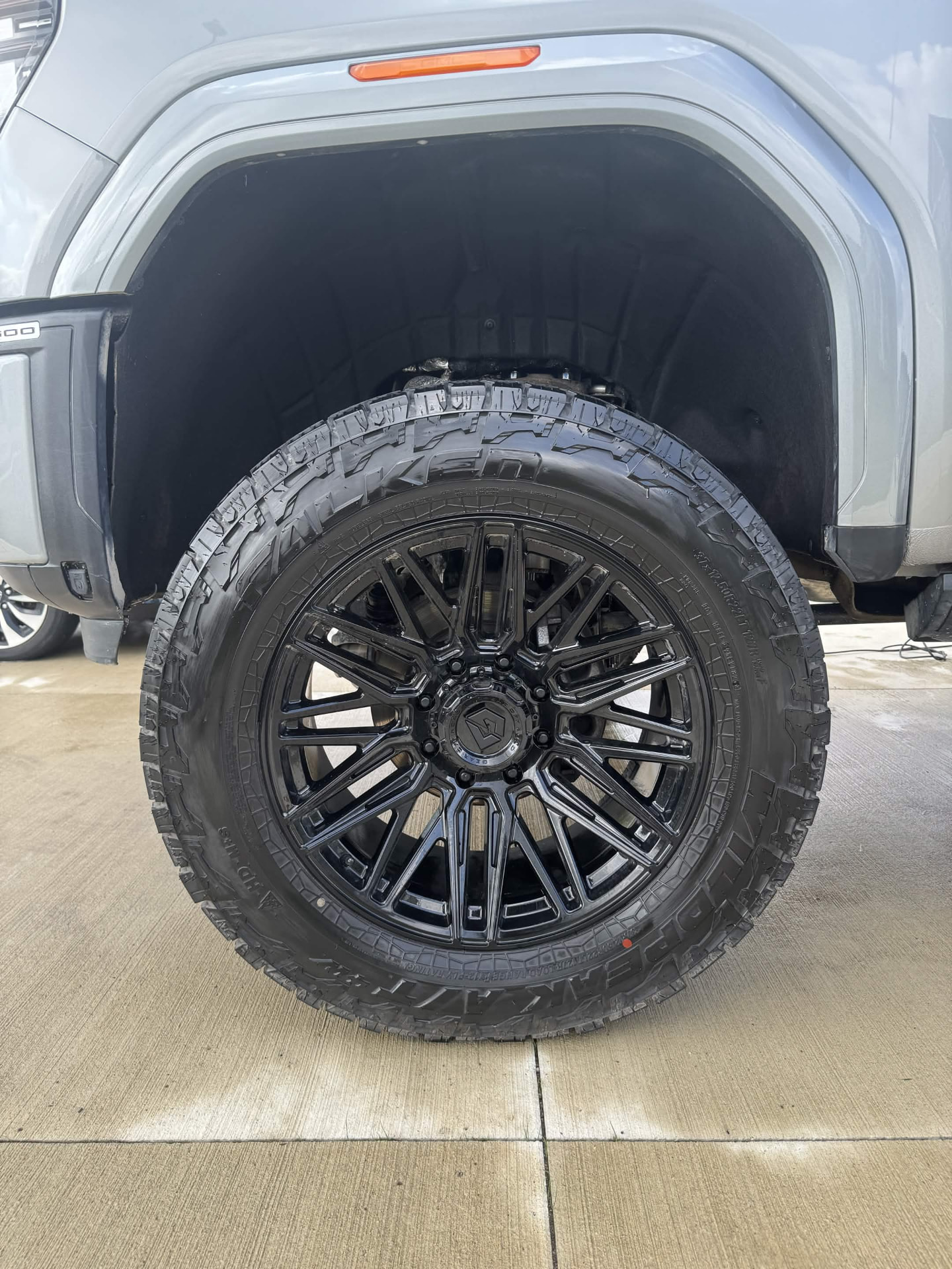 Same truck wheel and tire cleaned and dressed after detailing